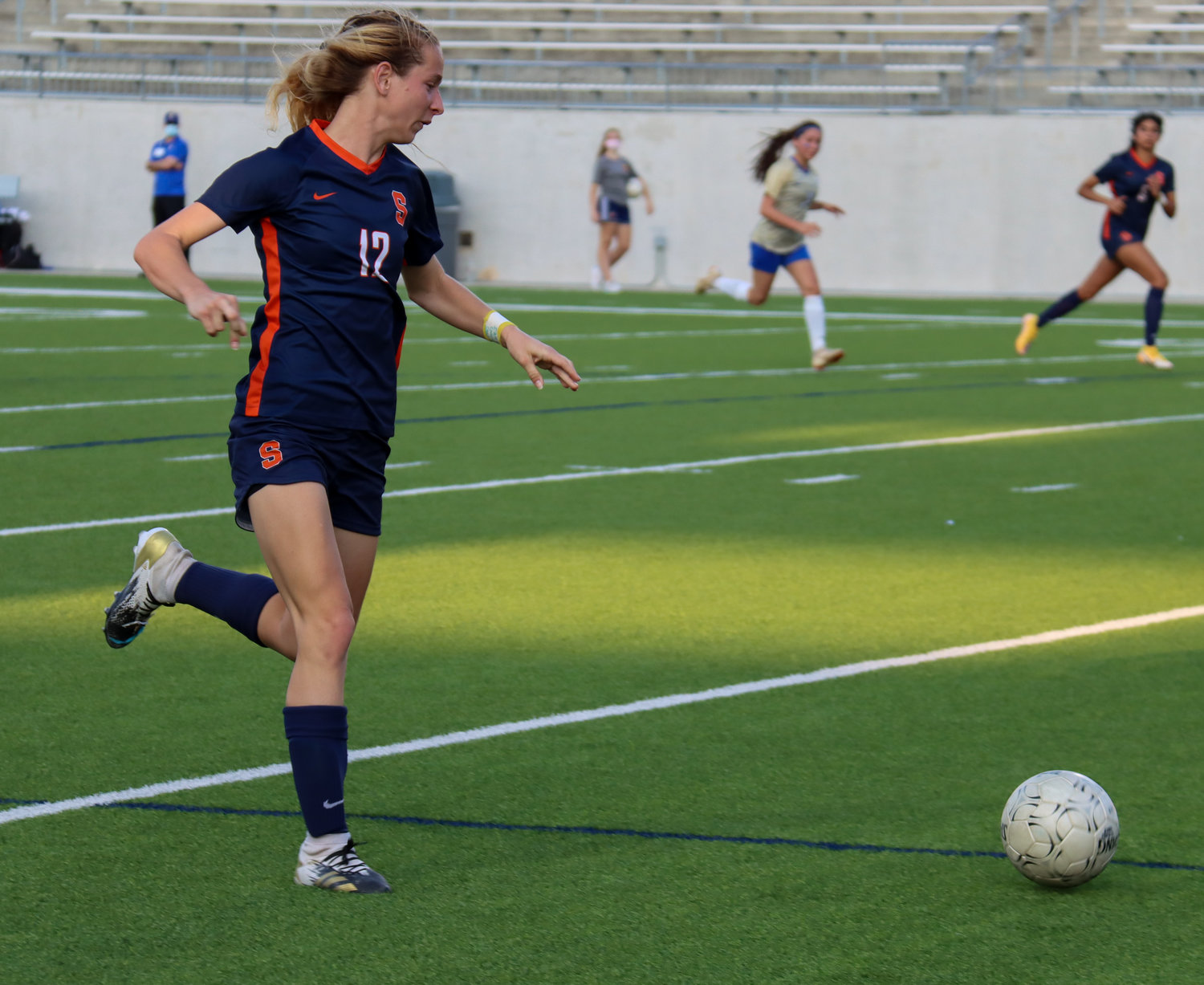 Seven Lakes senior forward Paige Boucher attacks downfield against an Elkins defender during the Spartans’ 7-0 Class 6A bi-district playoff win on Friday, March 26, at Legacy Stadium.